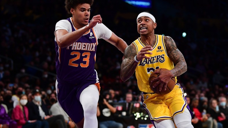 Dec 21, 2021; Los Angeles, California, USA; Los Angeles Lakers guard Isaiah Thomas (31) moves the ball against Phoenix Suns forward Cameron Johnson (23) during the first half at Staples Center. Mandatory Credit: Gary A. Vasquez-USA TODAY Sports