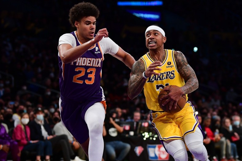 Dec 21, 2021; Los Angeles, California, USA; Los Angeles Lakers guard Isaiah Thomas (31) moves the ball against Phoenix Suns forward Cameron Johnson (23) during the first half at Staples Center. Mandatory Credit: Gary A. Vasquez-USA TODAY Sports
