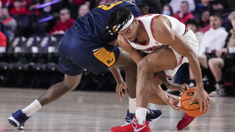 Dec 22, 2021; Athens, Georgia, USA; Georgia Bulldogs guard Aaron Cook (10) and East Tennessee State Buccaneers forward Vonnie Patterson (23) fight for a loose ball during the first half at Stegeman Coliseum. Mandatory Credit: Dale Zanine-USA TODAY Sports