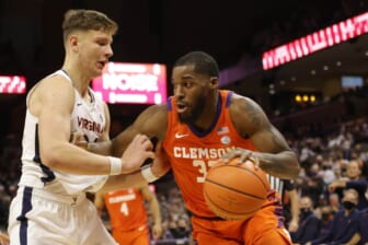 Dec 22, 2021; Charlottesville, Virginia, USA; Clemson Tigers forward Naz Bohannon (33) drives to the basket as Virginia Cavaliers guard Igor Milicic Jr. (24) defends during the first half at John Paul Jones Arena. Mandatory Credit: Geoff Burke-USA TODAY Sports