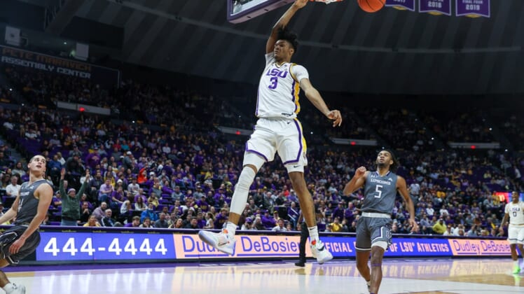 Dec 22, 2021; Baton Rouge, Louisiana, USA;  LSU Tigers forward Alex Fudge (3) dunks the ball against Lipscomb Bisons forward Kaleb Coleman (5) during the first half at Pete Maravich Assembly Center. Mandatory Credit: Stephen Lew-USA TODAY Sports