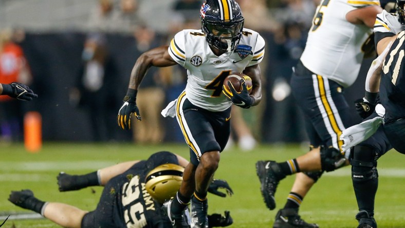 Dec 22, 2021; Fort Worth, Texas, USA; Missouri Tigers running back Elijah Young (4) breaks through a hole in the line against the Missouri Tigers during the first quarter of the 2021 Armed Forces Bowl at Amon G. Carter Stadium. Mandatory Credit: Andrew Dieb-USA TODAY Sports