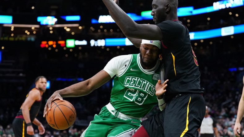 Dec 22, 2021; Boston, Massachusetts, USA; Boston Celtics forward Bruno Fernando (28) drives against Cleveland Cavaliers center Tacko Fall (99) in the second half at TD Garden. Mandatory Credit: David Butler II-USA TODAY Sports