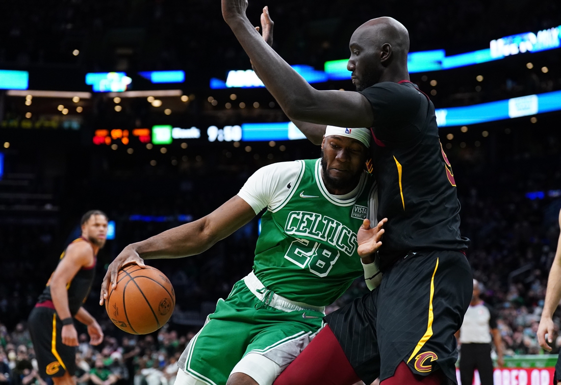 Dec 22, 2021; Boston, Massachusetts, USA; Boston Celtics forward Bruno Fernando (28) drives against Cleveland Cavaliers center Tacko Fall (99) in the second half at TD Garden. Mandatory Credit: David Butler II-USA TODAY Sports