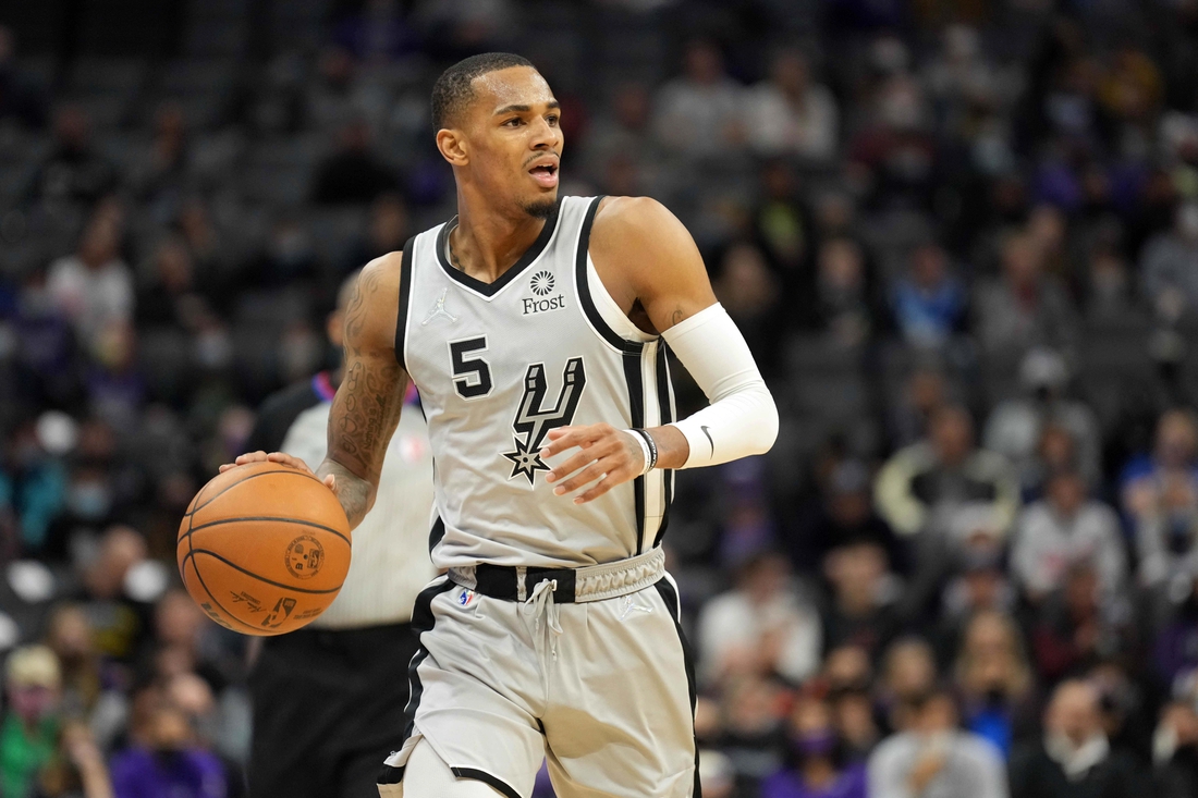 Dec 19, 2021; Sacramento, California, USA; San Antonio Spurs guard Dejounte Murray (5) dribbles during the second quarter against the Sacramento Kings at Golden 1 Center. Mandatory Credit: Darren Yamashita-USA TODAY Sports