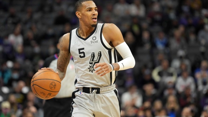 Dec 19, 2021; Sacramento, California, USA; San Antonio Spurs guard Dejounte Murray (5) dribbles during the second quarter against the Sacramento Kings at Golden 1 Center. Mandatory Credit: Darren Yamashita-USA TODAY Sports