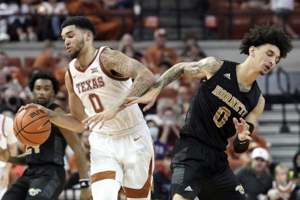 Dec 22, 2021; Austin, Texas, USA; Texas Longhorns forward Timmy Allen (0) is defended by Alabama State Hornets forward Trace Young (0) during the second half at Frank C. Erwin Jr. Center. Mandatory Credit: Scott Wachter-USA TODAY Sports