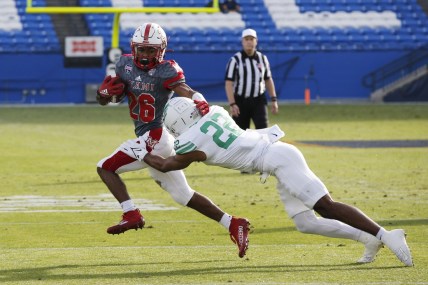 Dec 23, 2021; Frisco, TX, USA; Miami (Oh) Redhawks running back Kevin Davis (26) is tackled by North Texas Mean Green defensive back Keelan Crosby (22) in the first quarter at Toyota Stadium. Mandatory Credit: Tim Heitman-USA TODAY Sports