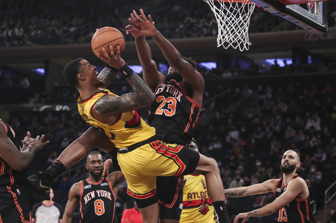 Dec 25, 2021; New York, New York, USA;  Atlanta Hawks forward John Collins (20) goes up against New York Knicks center Mitchell Robinson (23) in the first quarter at Madison Square Garden. Mandatory Credit: Wendell Cruz-USA TODAY Sports