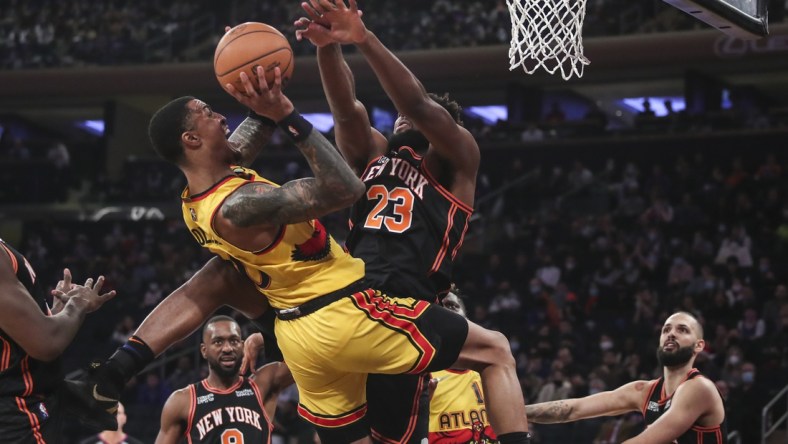 Dec 25, 2021; New York, New York, USA;  Atlanta Hawks forward John Collins (20) goes up against New York Knicks center Mitchell Robinson (23) in the first quarter at Madison Square Garden. Mandatory Credit: Wendell Cruz-USA TODAY Sports