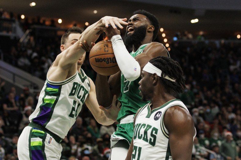 Dec 25, 2021; Milwaukee, Wisconsin, USA;  Milwaukee Bucks guard Pat Connaughton (24) defends Boston Celtics guard Jaylen Brown (7) during the third quarter at Fiserv Forum. Mandatory Credit: Jeff Hanisch-USA TODAY Sports