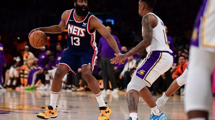 Dec 25, 2021; Los Angeles, California, USA; Brooklyn Nets guard James Harden (13) controls the ball against Los Angeles Lakers guard Malik Monk (11) during the first half at Crypto.com Arena. Mandatory Credit: Gary A. Vasquez-USA TODAY Sports