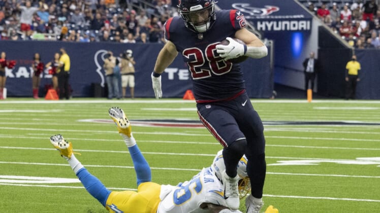 Dec 26, 2021; Houston, Texas, USA;  Houston Texans running back Rex Burkhead (28) runs for a touchdown against Los Angeles Chargers defensive back Trey Marshall (36) in the first quarter at NRG Stadium. Mandatory Credit: Thomas Shea-USA TODAY Sports