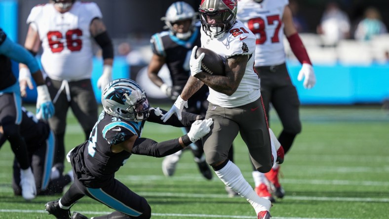 Dec 26, 2021; Charlotte, North Carolina, USA; Tampa Bay Buccaneers running back Ke'Shawn Vaughn (21) runs the ball against Carolina Panthers free safety Juston Burris (31) during the first quarter at Bank of America Stadium. Mandatory Credit: Jim Dedmon-USA TODAY Sports