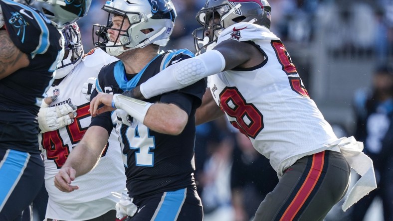 Dec 26, 2021; Charlotte, North Carolina, USA; Carolina Panthers quarterback Sam Darnold (14) is hit by Tampa Bay Buccaneers outside linebacker Shaquil Barrett (58) after the throw during the second quarter at Bank of America Stadium. Mandatory Credit: Jim Dedmon-USA TODAY Sports