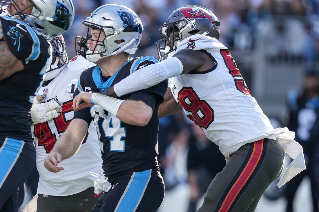 Dec 26, 2021; Charlotte, North Carolina, USA; Carolina Panthers quarterback Sam Darnold (14) is hit by Tampa Bay Buccaneers outside linebacker Shaquil Barrett (58) after the throw during the second quarter at Bank of America Stadium. Mandatory Credit: Jim Dedmon-USA TODAY Sports
