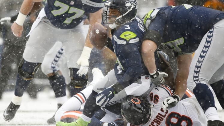 Dec 26, 2021; Seattle, Washington, USA; Seattle Seahawks quarterback Russell Wilson (3) is sacked by Chicago Bears defensive end Bilal Nichols (98) during the first quarter at Lumen Field. Mandatory Credit: Joe Nicholson-USA TODAY Sports