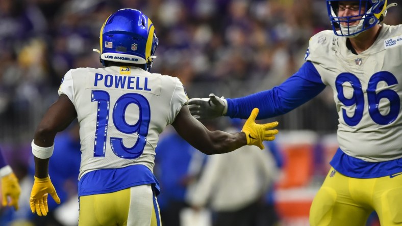 Dec 26, 2021; Minneapolis, Minnesota, USA; Los Angeles Rams wide receiver Brandon Powell (19) reacts with defensive end Mike Hoecht (96) against the Minnesota Vikings during the third quarter at U.S. Bank Stadium. Mandatory Credit: Jeffrey Becker-USA TODAY Sports