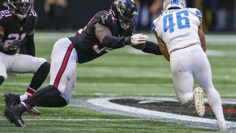 Dec 26, 2021; Atlanta, Georgia, USA; Detroit Lions running back Craig Reynolds (46) is tackled by Atlanta Falcons linebackers Foye Oluokun (54) during the second half at Mercedes-Benz Stadium. Mandatory Credit: Dale Zanine-USA TODAY Sports