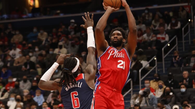 Dec 26, 2021; Washington, District of Columbia, USA; Philadelphia 76ers center Joel Embiid (21) shoots the ball over Washington Wizards center Montrezl Harrell (6) during the second quarter at Capital One Arena. Mandatory Credit: Geoff Burke-USA TODAY Sports