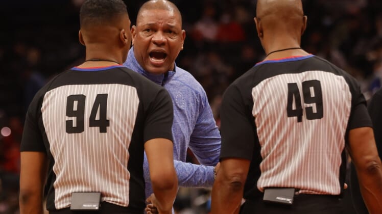 Dec 26, 2021; Washington, District of Columbia, USA; Philadelphia 76ers head coach Doc Rivers argues with referees Jamahl Ralls (94) and Tom Washington (49) during a timeout against the Washington Wizards during the second quarter at Capital One Arena. Mandatory Credit: Geoff Burke-USA TODAY Sports