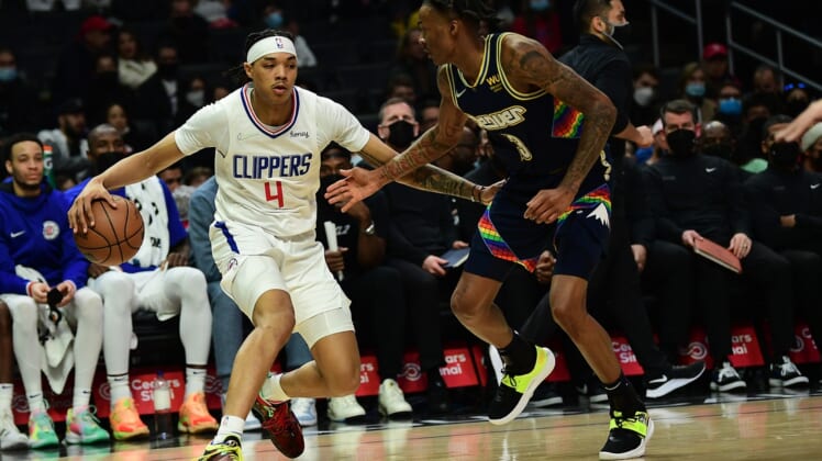 Dec 26, 2021; Los Angeles, California, USA; Los Angeles Clippers guard Brandon Boston Jr. (4) moves the ball against Denver Nuggets guard Bones Hyland (3) during the first half at Crypto.com Arena. Mandatory Credit: Gary A. Vasquez-USA TODAY Sports