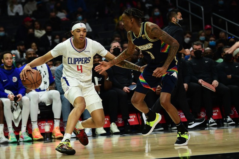 Dec 26, 2021; Los Angeles, California, USA; Los Angeles Clippers guard Brandon Boston Jr. (4) moves the ball against Denver Nuggets guard Bones Hyland (3) during the first half at Crypto.com Arena. Mandatory Credit: Gary A. Vasquez-USA TODAY Sports