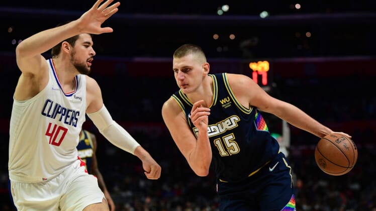 Dec 26, 2021; Los Angeles, California, USA; Denver Nuggets center Nikola Jokic (15) moves to the basket against Los Angeles Clippers center Ivica Zubac (40) during the second half at Crypto.com Arena. Mandatory Credit: Gary A. Vasquez-USA TODAY Sports