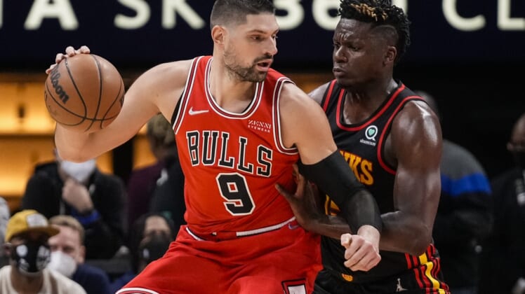 Dec 27, 2021; Atlanta, Georgia, USA; Chicago Bulls center Nikola Vucevic (9) tries to get to the basket guarded by Atlanta Hawks center Clint Capela (15) during the first half at State Farm Arena. Mandatory Credit: Dale Zanine-USA TODAY Sports