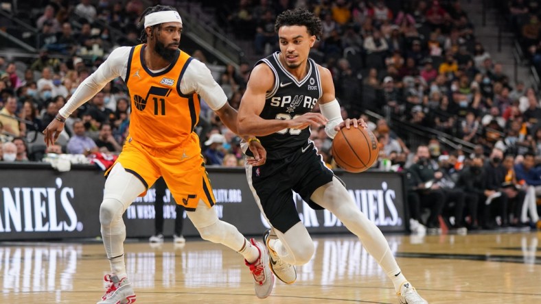 Dec 27, 2021; San Antonio, Texas, USA;San Antonio Spurs guard Tre Jones (33) dribbles against Utah Jazz guard Mike Conley (11) in the second half at the AT&T Center. Mandatory Credit: Daniel Dunn-USA TODAY Sports