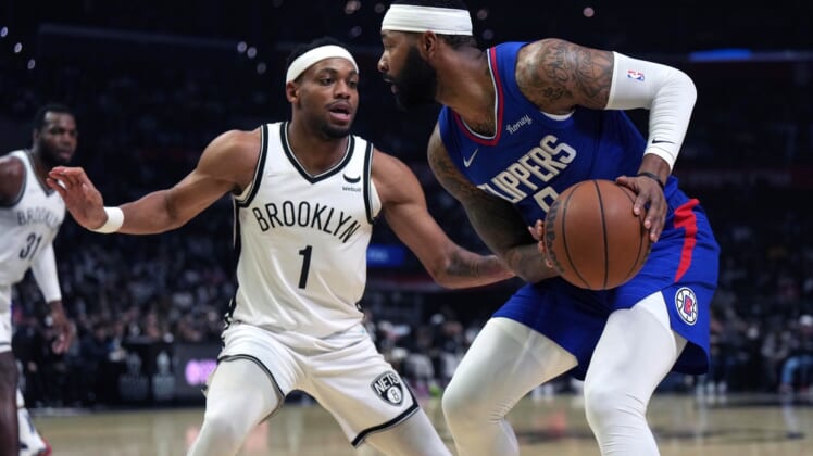Dec 27, 2021; Los Angeles, California, USA; LA Clippers forward Marcus Morris Sr. (right) controls the ball while defended by Brooklyn Nets forward Bruce Brown (1) in the first half at Crypto.com Arena. Mandatory Credit: Kirby Lee-USA TODAY Sports