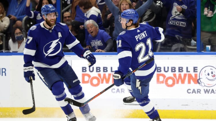 Dec 28, 2021; Tampa, Florida, USA;Tampa Bay Lightning center Brayden Point (21) is congratulated by defenseman Victor Hedman (77) as he scores a goal against the Montreal Canadiens  during the first period at Amalie Arena. Mandatory Credit: Kim Klement-USA TODAY Sports