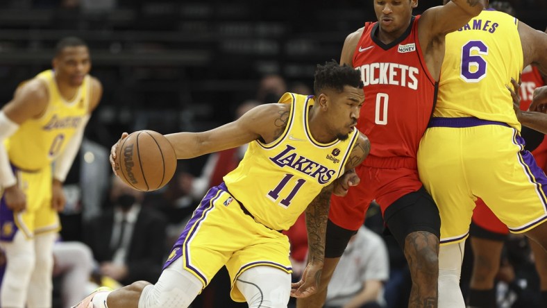 Dec 28, 2021; Houston, Texas, USA; Los Angeles Lakers guard Malik Monk (11) attempts to dribble the ball around Houston Rockets guard Jalen Green (0) during the first quarter at Toyota Center. Mandatory Credit: Troy Taormina-USA TODAY Sports