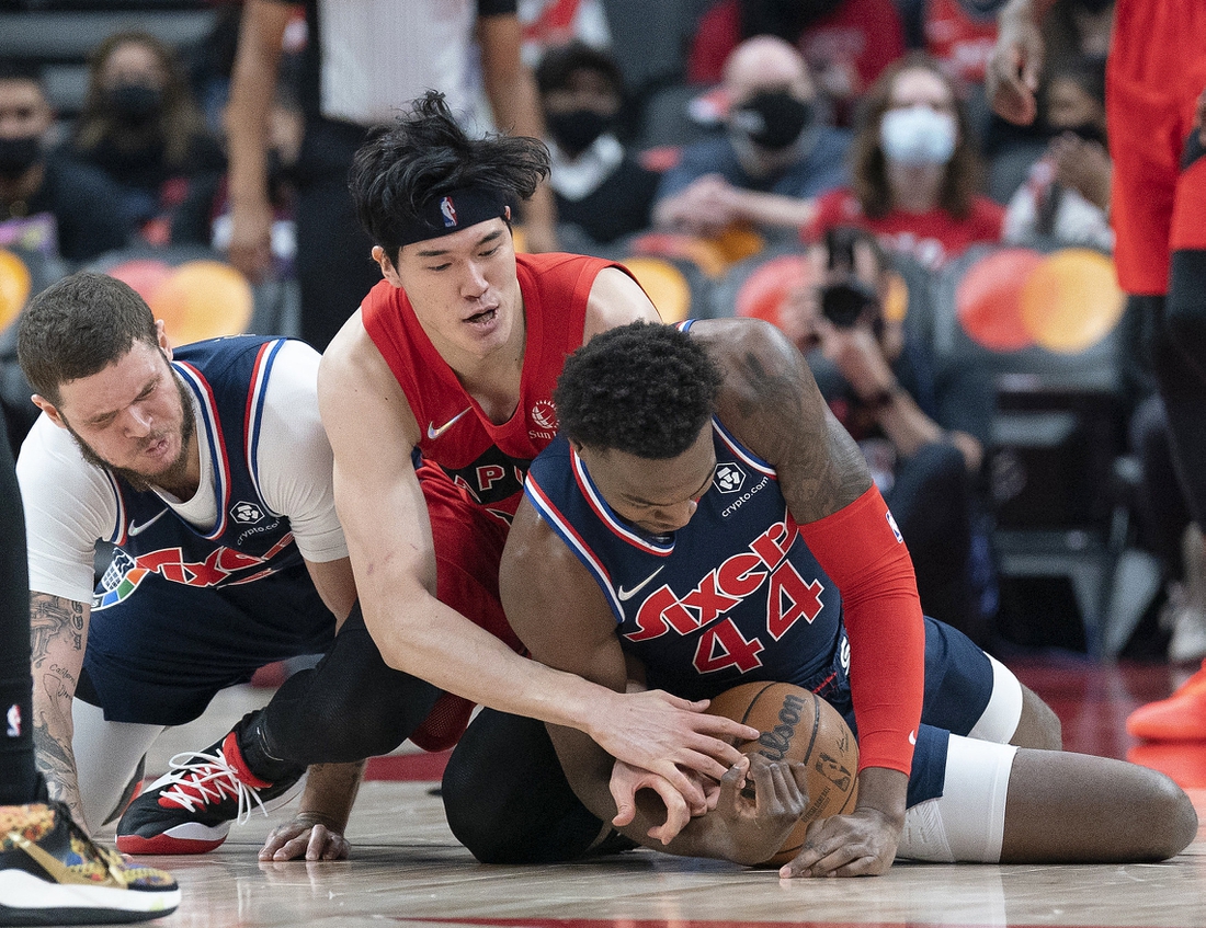 Dec 28, 2021; Toronto, Ontario, CAN; Toronto Raptors forward Yuta Watanabe (18) battles for the ball with Philadelphia 76ers forward Paul Reed (44)) during the second quarter at Scotiabank Arena. Mandatory Credit: Nick Turchiaro-USA TODAY Sports