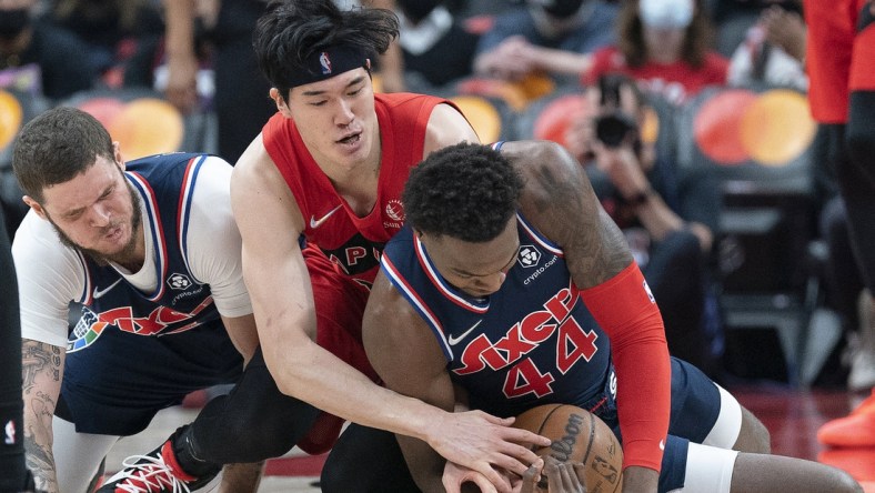 Dec 28, 2021; Toronto, Ontario, CAN; Toronto Raptors forward Yuta Watanabe (18) battles for the ball with Philadelphia 76ers forward Paul Reed (44)) during the second quarter at Scotiabank Arena. Mandatory Credit: Nick Turchiaro-USA TODAY Sports