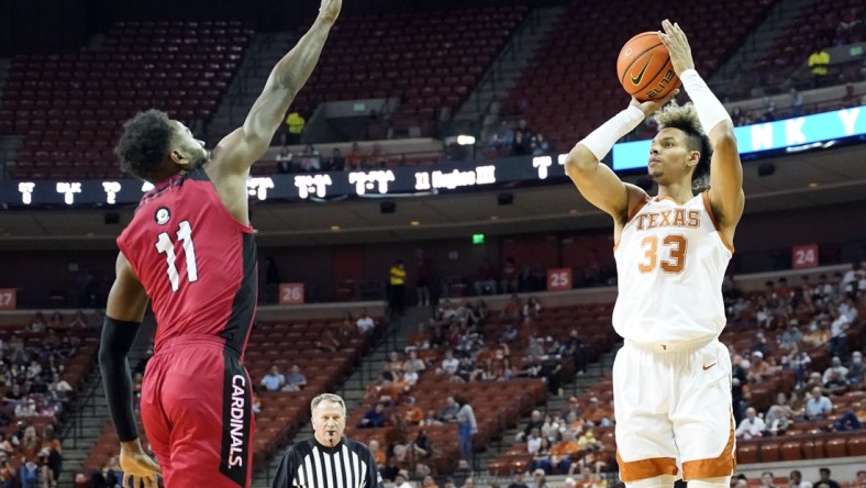 Dec 28, 2021; Austin, Texas, USA; Texas Longhorns forward Tre Mitchell (33) shoots over Incarnate Word Cardinals forward Johnny Hughes (11) during the first half at Frank C. Erwin Jr. Center. Mandatory Credit: Scott Wachter-USA TODAY Sports