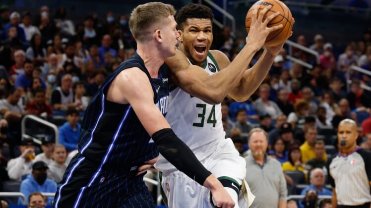 Dec 28, 2021; Orlando, Florida, USA;  Milwaukee Bucks forward Giannis Antetokounmpo (34) drives to the basket past Orlando Magic center Moritz Wagner (21) in the second half at Amway Center. Mandatory Credit: Nathan Ray Seebeck-USA TODAY Sports