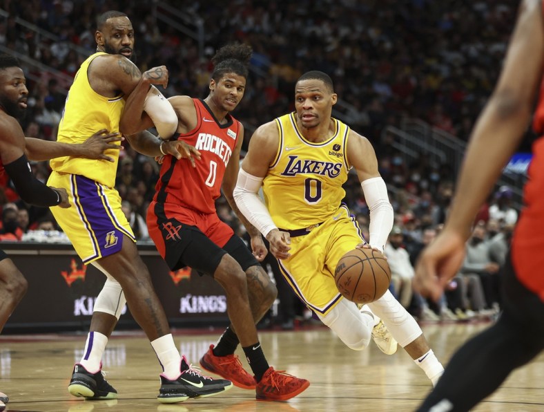 Dec 28, 2021; Houston, Texas, USA; Los Angeles Lakers guard Russell Westbrook (0) dribbles the ball around Houston Rockets guard Jalen Green (0) during the fourth quarter at Toyota Center. Mandatory Credit: Troy Taormina-USA TODAY Sports