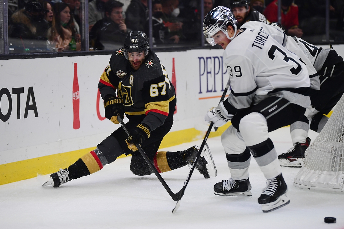 Dec 28, 2021; Los Angeles, California, USA; Vegas Golden Knights left wing Max Pacioretty (67) passes the puck against Los Angeles Kings center Alex Turcotte (39) during the first period at Crypto.com Arena. Mandatory Credit: Gary A. Vasquez-USA TODAY Sports