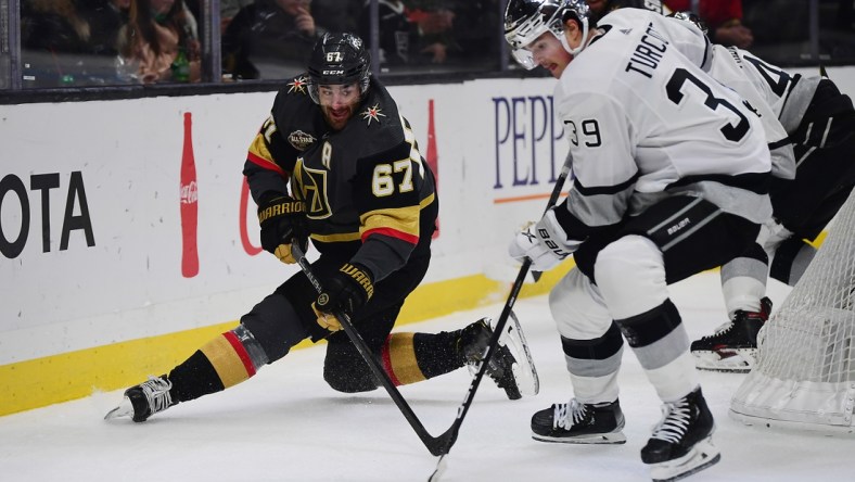 Dec 28, 2021; Los Angeles, California, USA; Vegas Golden Knights left wing Max Pacioretty (67) passes the puck against Los Angeles Kings center Alex Turcotte (39) during the first period at Crypto.com Arena. Mandatory Credit: Gary A. Vasquez-USA TODAY Sports