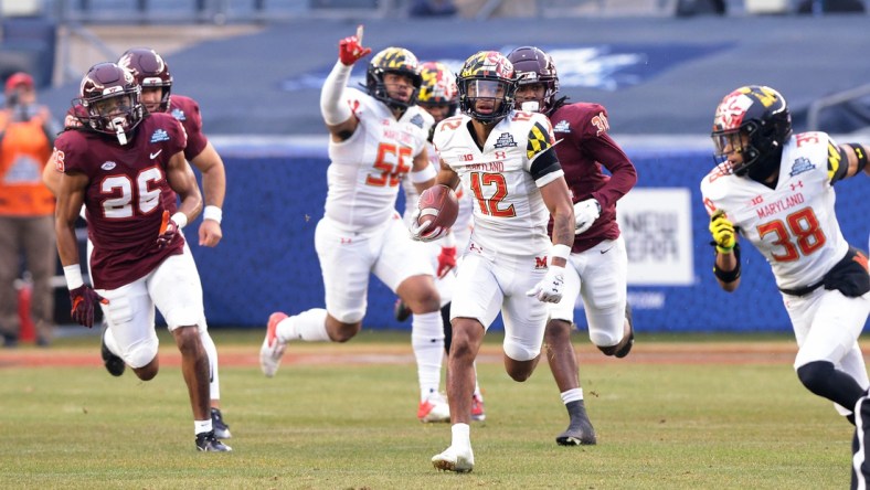 Dec 29, 2021; New York, NY, USA; Maryland Terrapins punt returner Tarheeb Still (12) returns a punt for a touchdown during the first half during the 2021 Pinstripe Bowl against the Virginia Tech Hokies at Yankee Stadium. Mandatory Credit: Vincent Carchietta-USA TODAY Sports