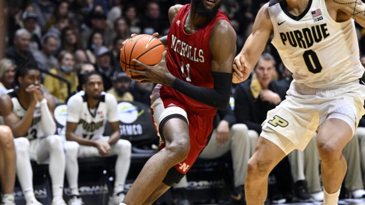 Dec 29, 2021; West Lafayette, Indiana, USA; Nicholls State Colonels guard Latrell Jones (11) drives to the basket around Purdue Boilermakers forward Mason Gillis (0) during the first half at Mackey Arena. Mandatory Credit: Marc Lebryk-USA TODAY Sports