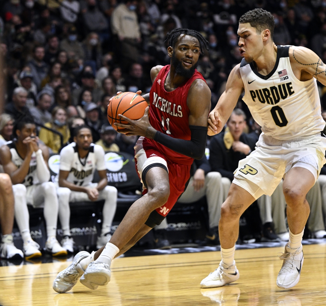 Dec 29, 2021; West Lafayette, Indiana, USA; Nicholls State Colonels guard Latrell Jones (11) drives to the basket around Purdue Boilermakers forward Mason Gillis (0) during the first half at Mackey Arena. Mandatory Credit: Marc Lebryk-USA TODAY Sports