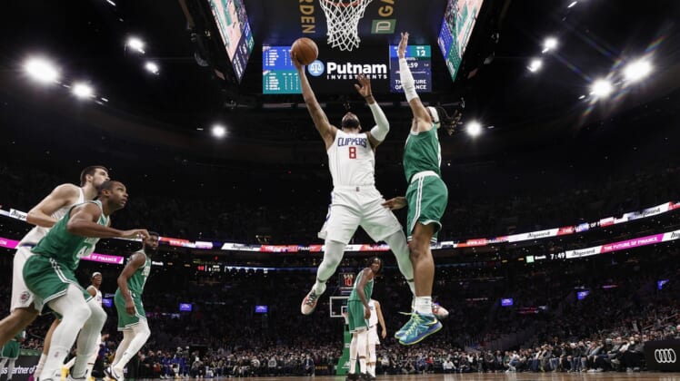 Dec 29, 2021; Boston, Massachusetts, USA; LA Clippers forward Marcus Morris Sr. (8) goes to the basket against Boston Celtics guard Romeo Langford (9) during the second quarter at TD Garden. Mandatory Credit: Winslow Townson-USA TODAY Sports
