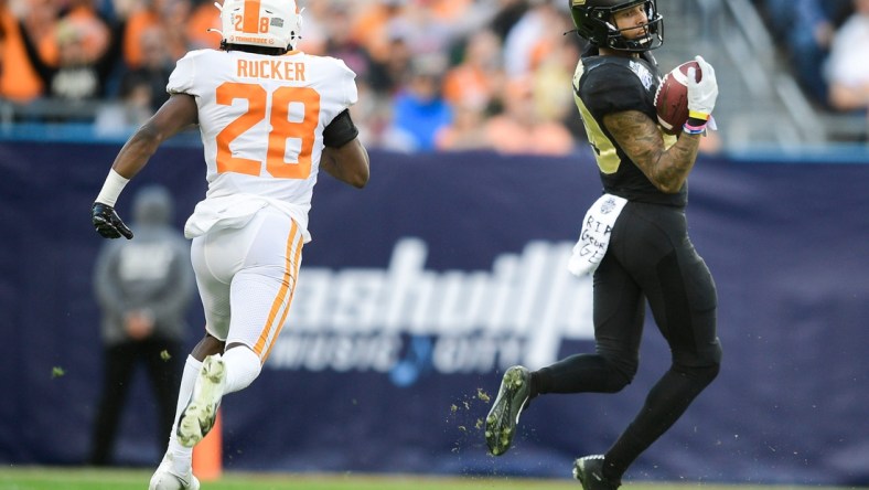 Purdue wide receiver Broc Thompson (29) catches a pass as Tennessee defensive back De'Shawn Rucker (28) defends at the 2021 Music City Bowl NCAA college football game at Nissan Stadium in Nashville, Tenn. on Thursday, Dec. 30, 2021.

Kns Tennessee Purdue