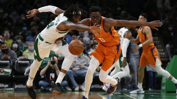 Dec 31, 2021; Boston, Massachusetts, USA; Boston Celtics center Robert Williams III (44) plays for the ball against Phoenix Suns forward Emanuel Terry (10) during the first half at TD Garden. Mandatory Credit: Winslow Townson-USA TODAY Sports