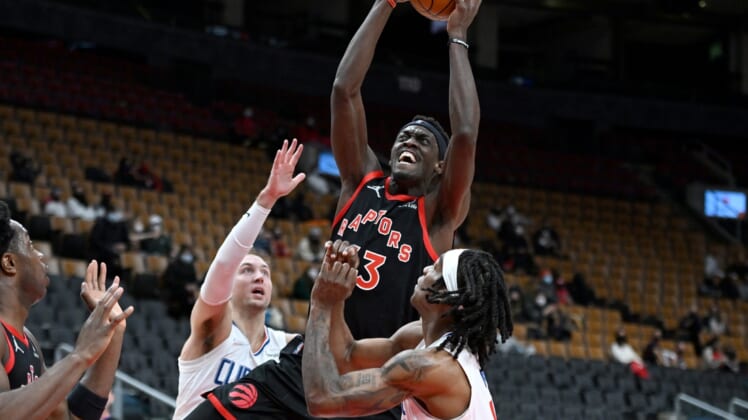 Dec 31, 2021; Toronto, Ontario, CAN;   Toronto Raptors forward Pascal Siakam (43) shoots the ball over Los Angeles Clippers guard Luke Kennard (5) and guard Terance Mann (14) in the first half at Scotiabank Arena. Mandatory Credit: Dan Hamilton-USA TODAY Sports