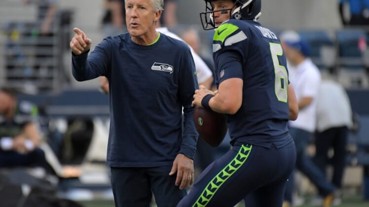 Aug 30, 2018; Seattle, WA, USA; Seattle Seahawks head coach Pete Carroll (left) talks with quarterback Austin Davis (6) against the Oakland Raiders during a preseason game at CenturyLink Field. The Raiders defeated the Seahawks 30-19. Mandatory Credit: Kirby Lee-USA TODAY Sports