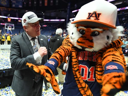 Mar 17, 2019; Nashville, TN, USA; Auburn Tigers head coach Bruce Pearl celebrates with Auburn Tigers mascot Aubie after beating the Tennessee Volunteers in the SEC conference tournament championship game at Bridgestone Arena. Mandatory Credit: Christopher Hanewinckel-USA TODAY Sports