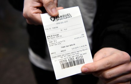 Dan Schiavone of Englewood shows his ticket after betting on the Louisville/Minnesota game on the first day of the NCAA basketball tournament at the Meadowlands Racetrack on Thursday, March 21, 2019 in East Rutherford. This is the first year sports fans can legally place bets during March Madness in New Jersey. 

Meadowlands March Madness Gambling